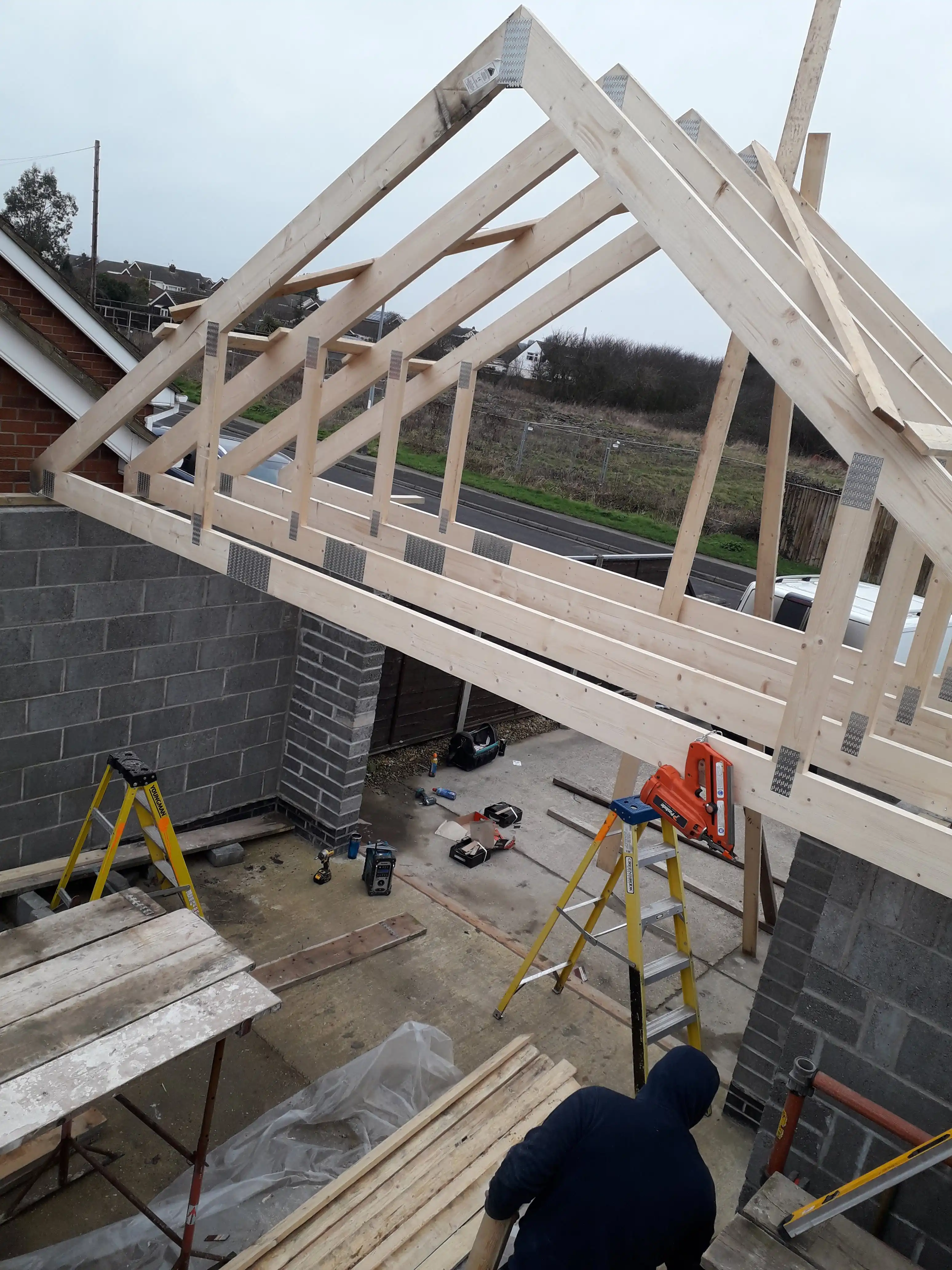 Foundations of a house roof being constructed using joinery techniques.
